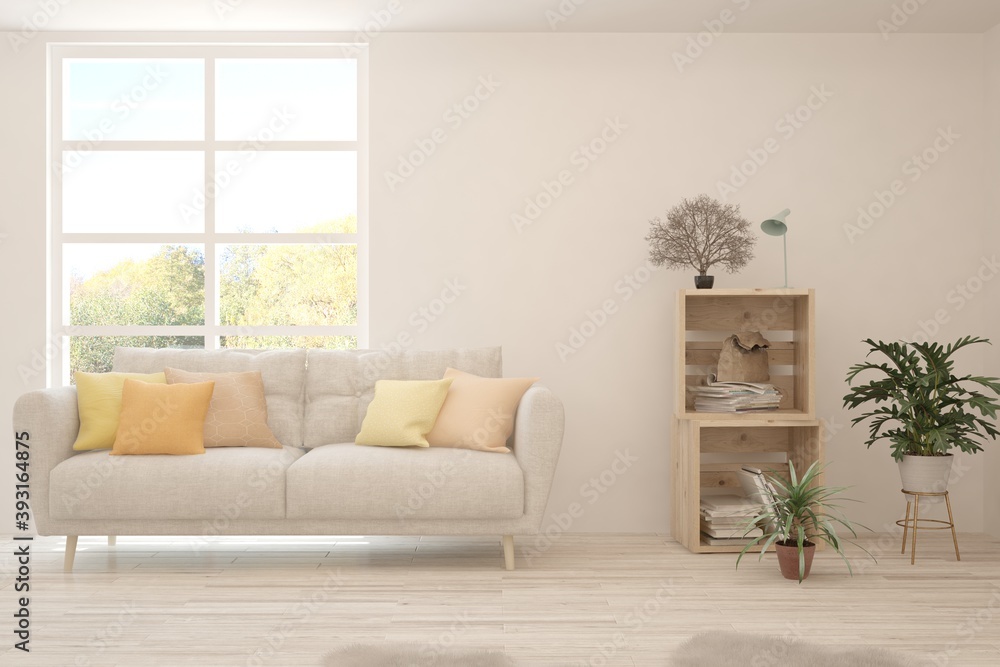 Stylish room in white color with sofa and autumn landscape in window. Scandinavian interior design. 