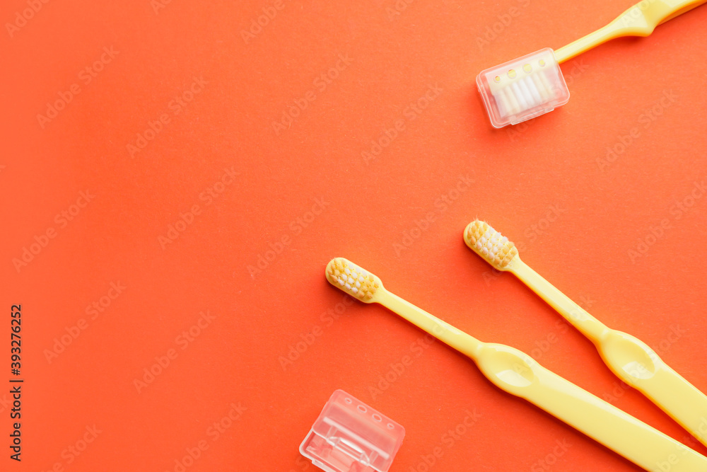 Toothbrushes on color background