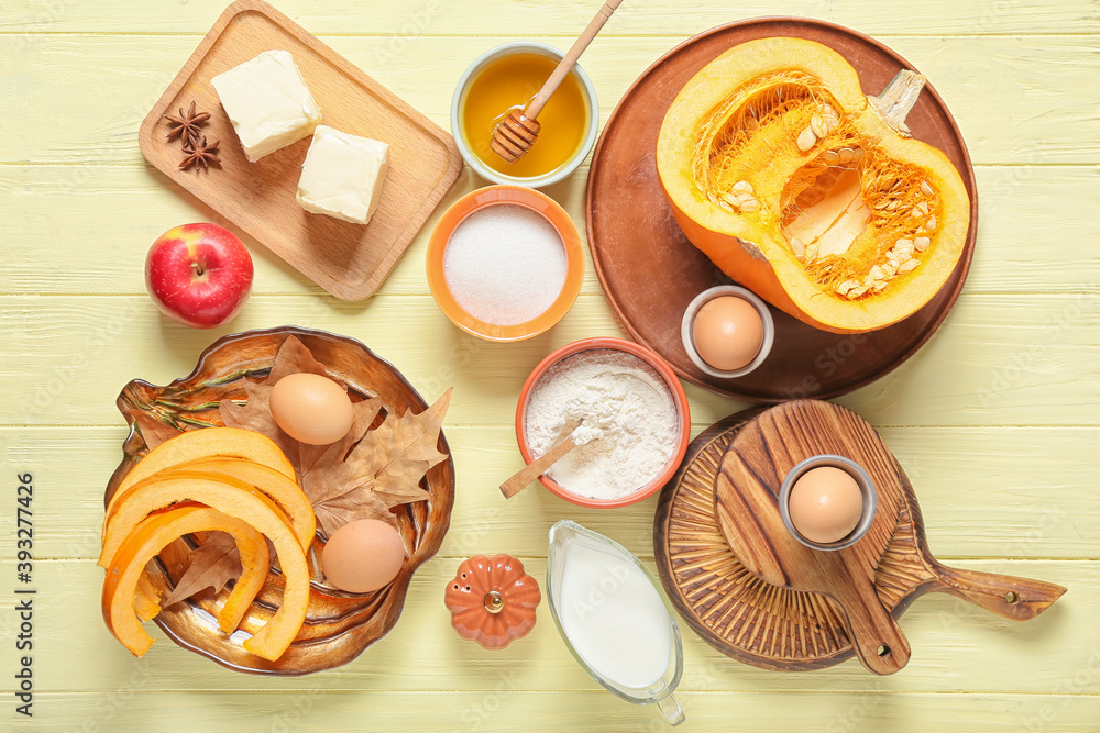 Ingredients for preparing pumpkin pie on color wooden background