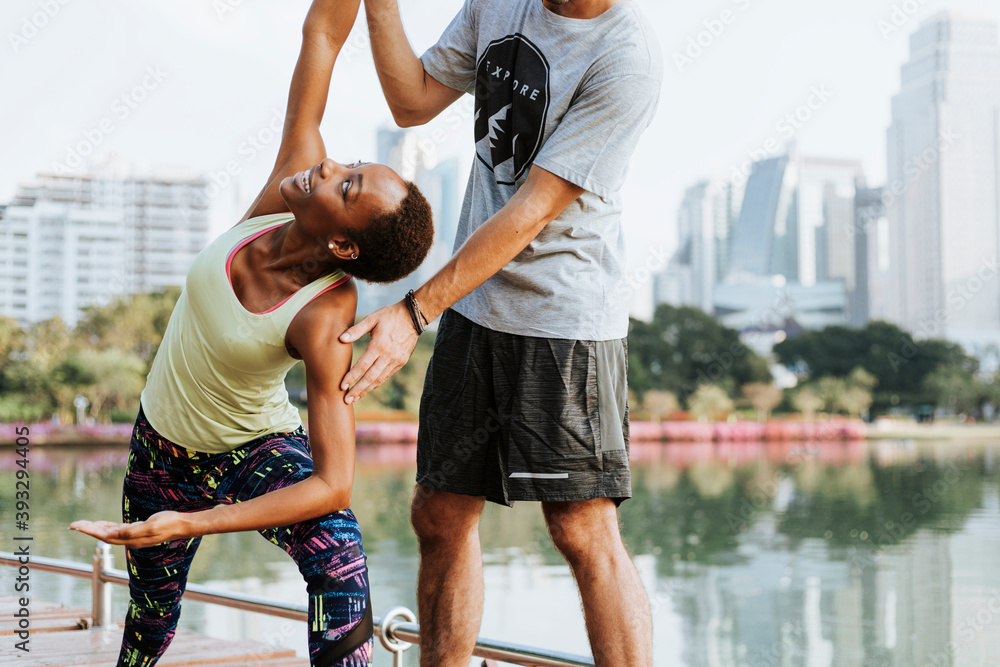 Couple doing a yoga in a park