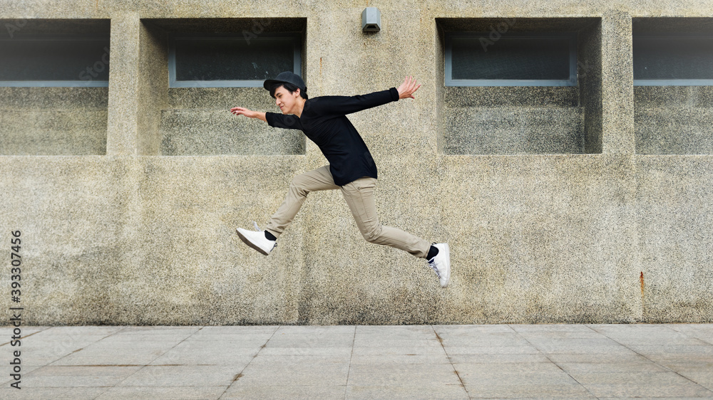 Boy jumping in mid-air on the street