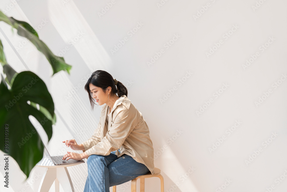 Asian woman working on her laptop