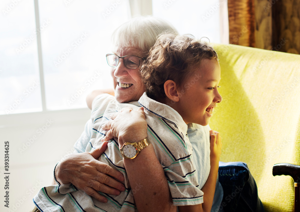 Grandma and grandson hugging after social distancing