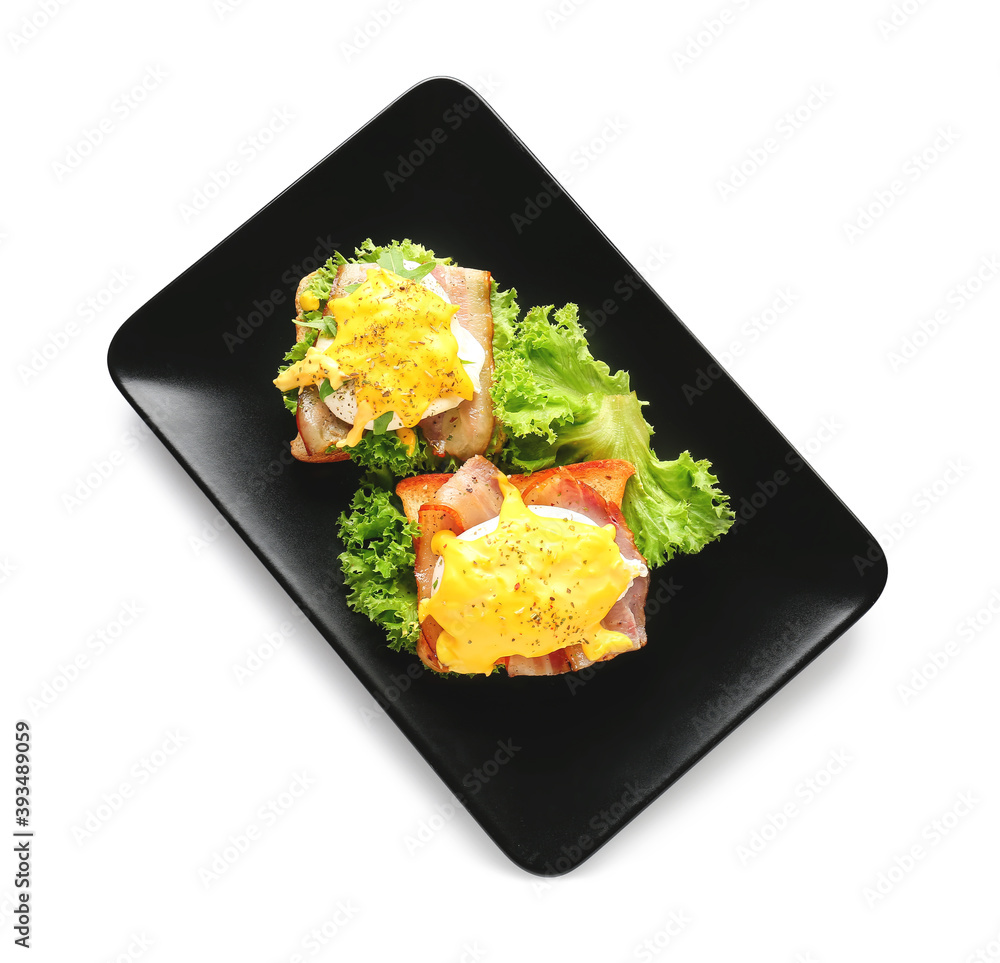 Plate with tasty eggs Benedict on white background