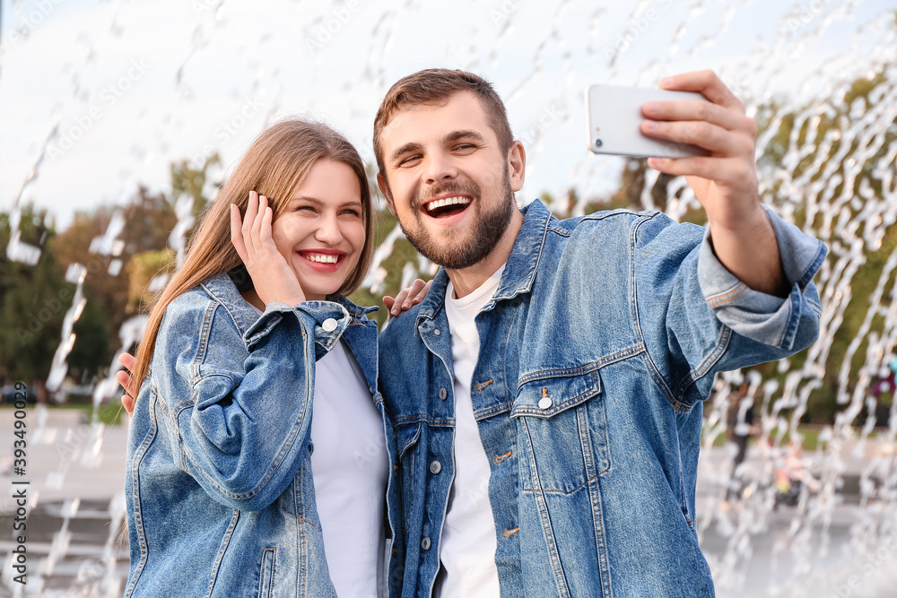 Young couple taking selfie outdoors