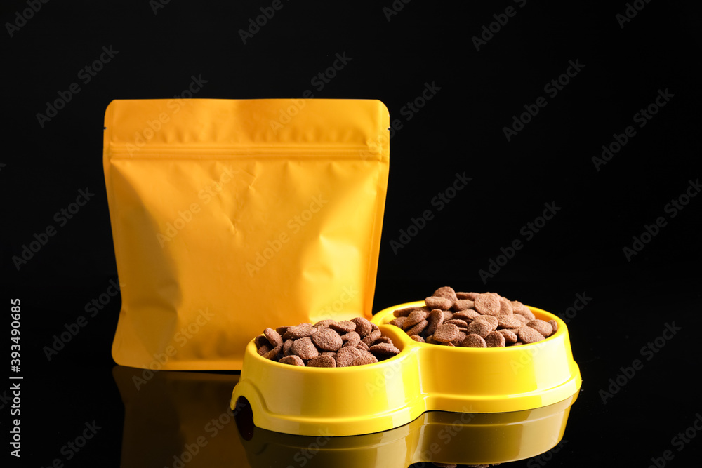 Tasty pet food on dark background