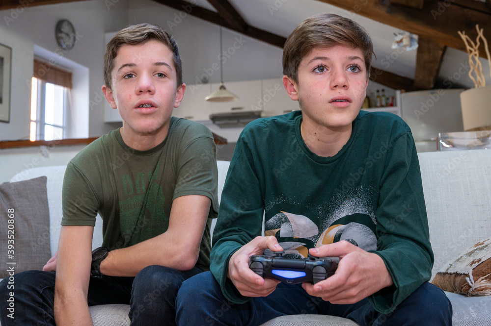 Adolescents jouant à la console de jeux à la maison