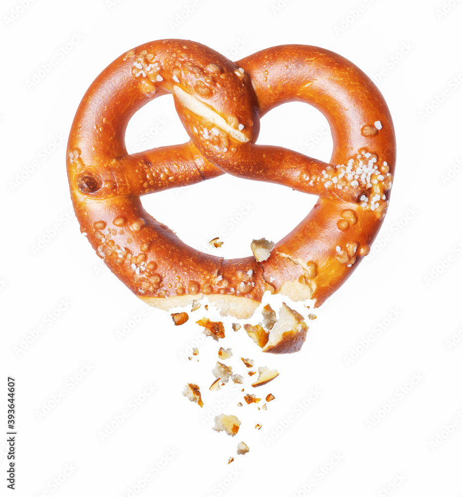 Freshly baked pretzel broken in the air on a white background