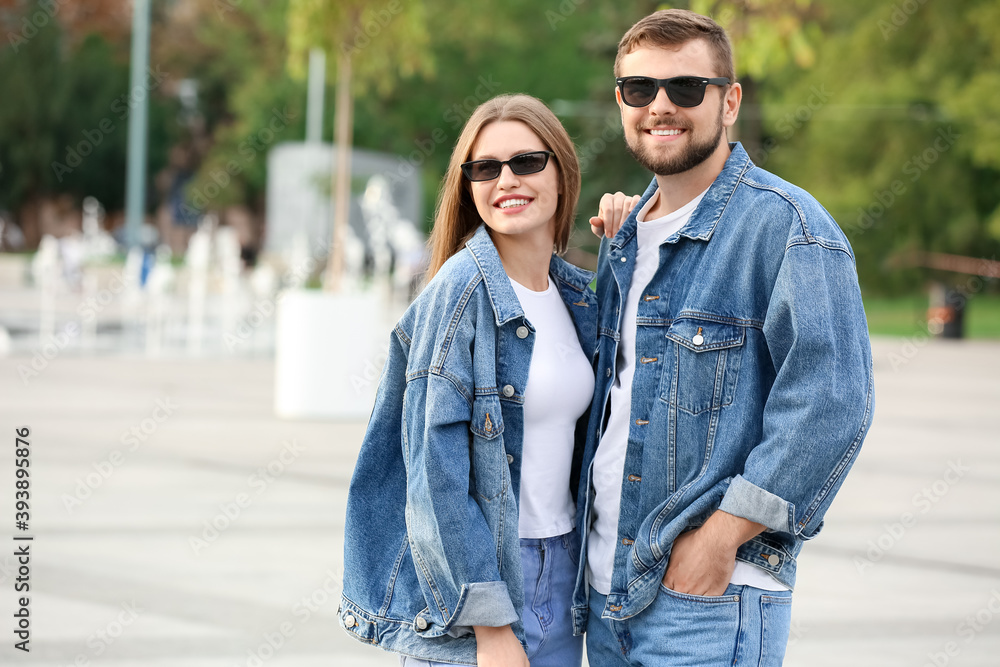 Young couple with stylish sunglasses outdoors