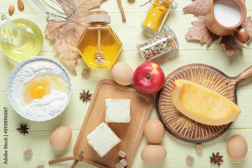 Ingredients for preparing pumpkin pie on color wooden background