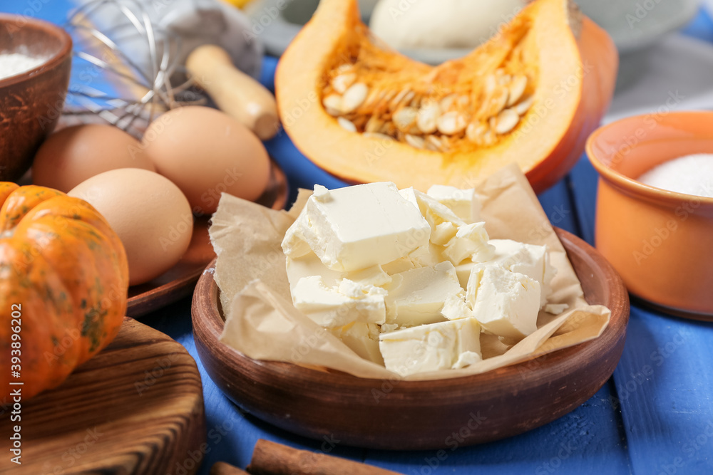 Ingredients for preparing pumpkin pie on color wooden background