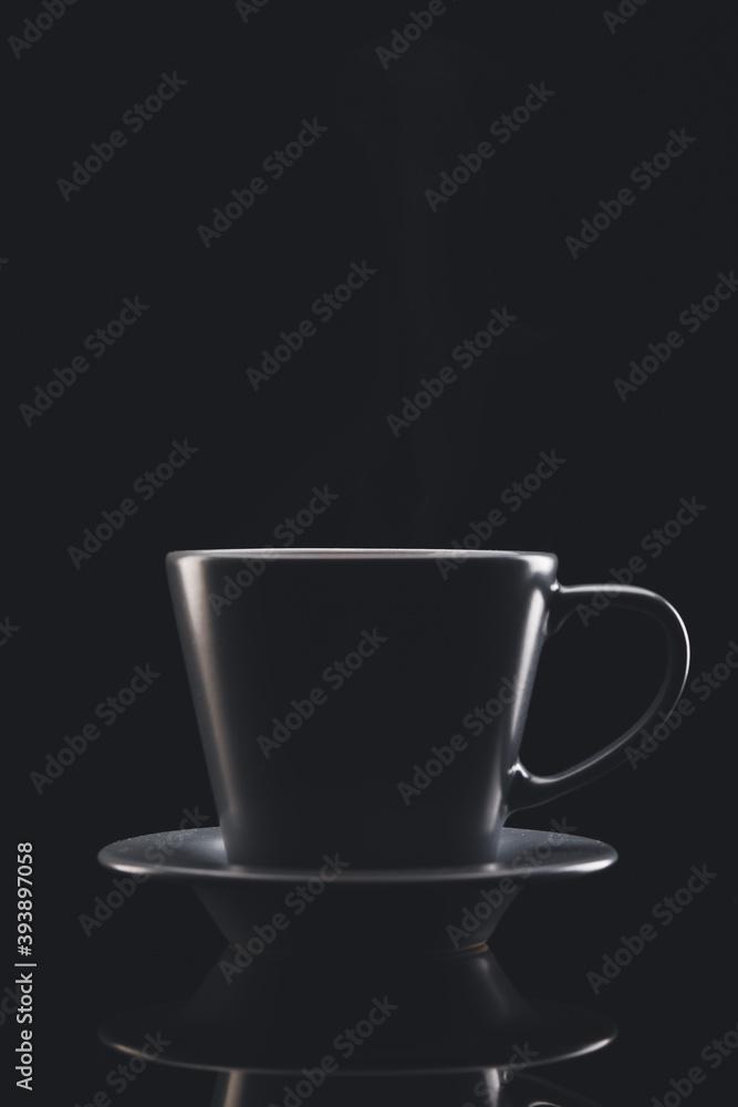 Cup of hot coffee on dark background