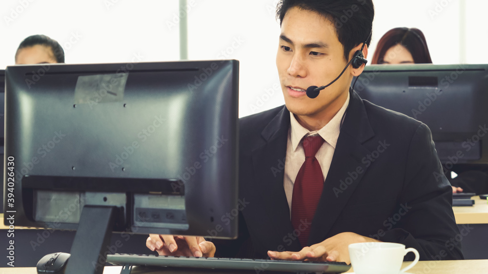 Business people wearing headset working in office to support remote customer or colleague. Call cent