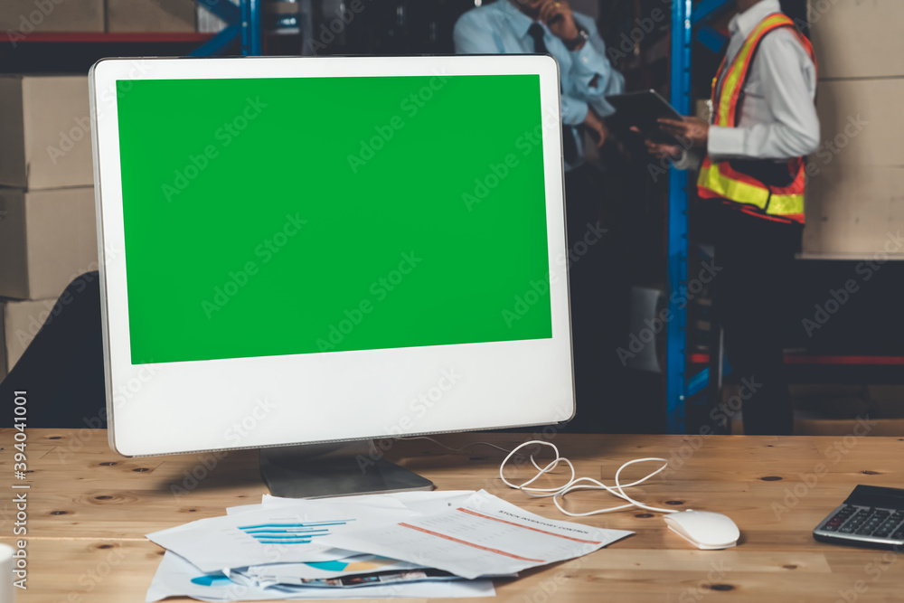 Computer with green screen display in warehouse storage room . Delivery and transportation software 