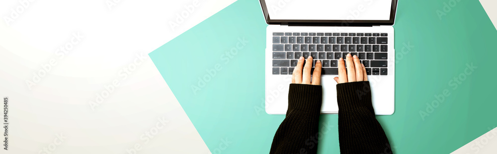 Person using a laptop computer from above