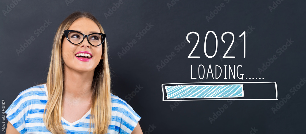 Loading new year 2021 with happy young woman in front of a blackboard