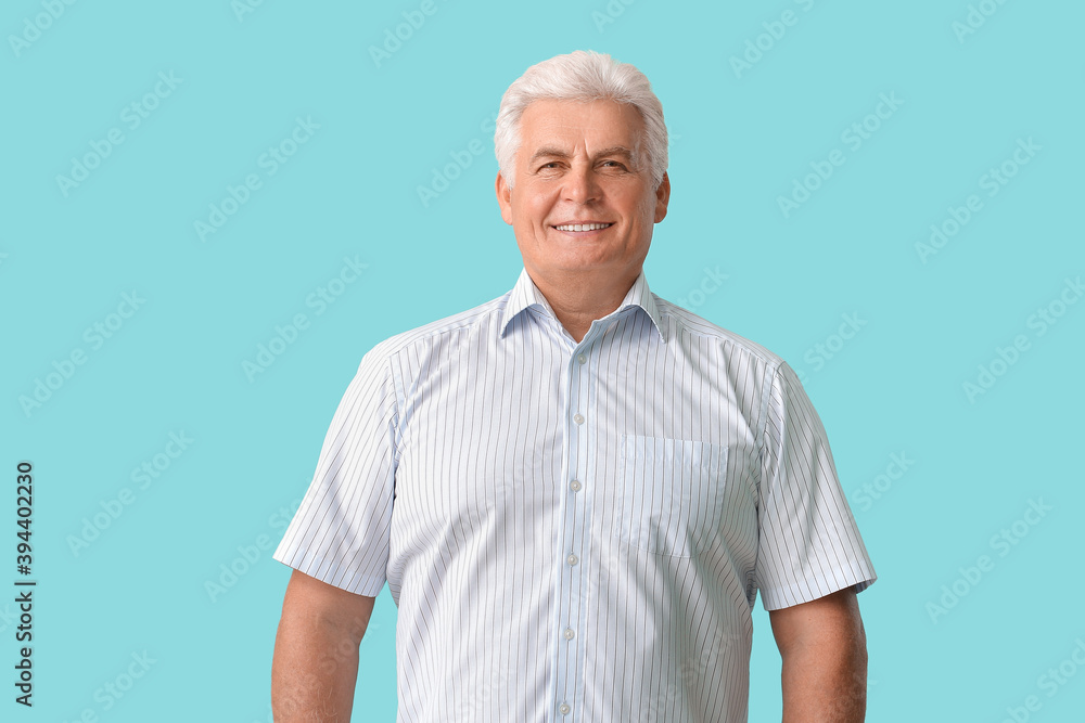 Stylish senior man on color background