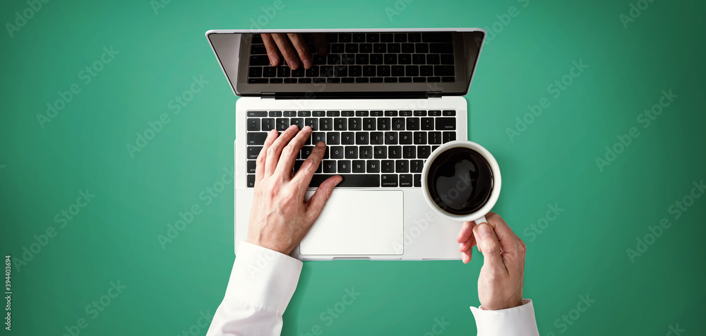 Businessman using a laptop computer overhead view