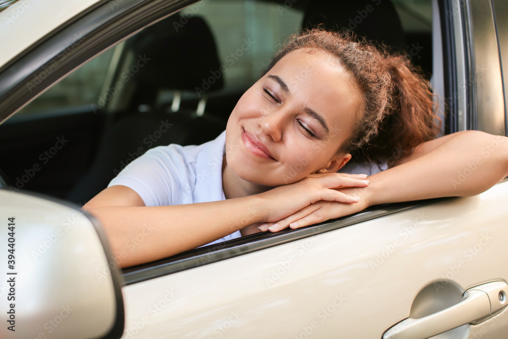 Young African-American female driver in car