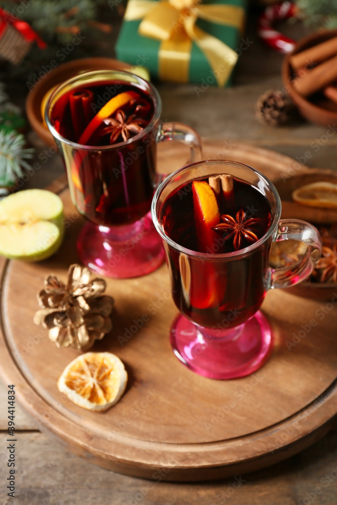 Glass cups of tasty mulled wine on table