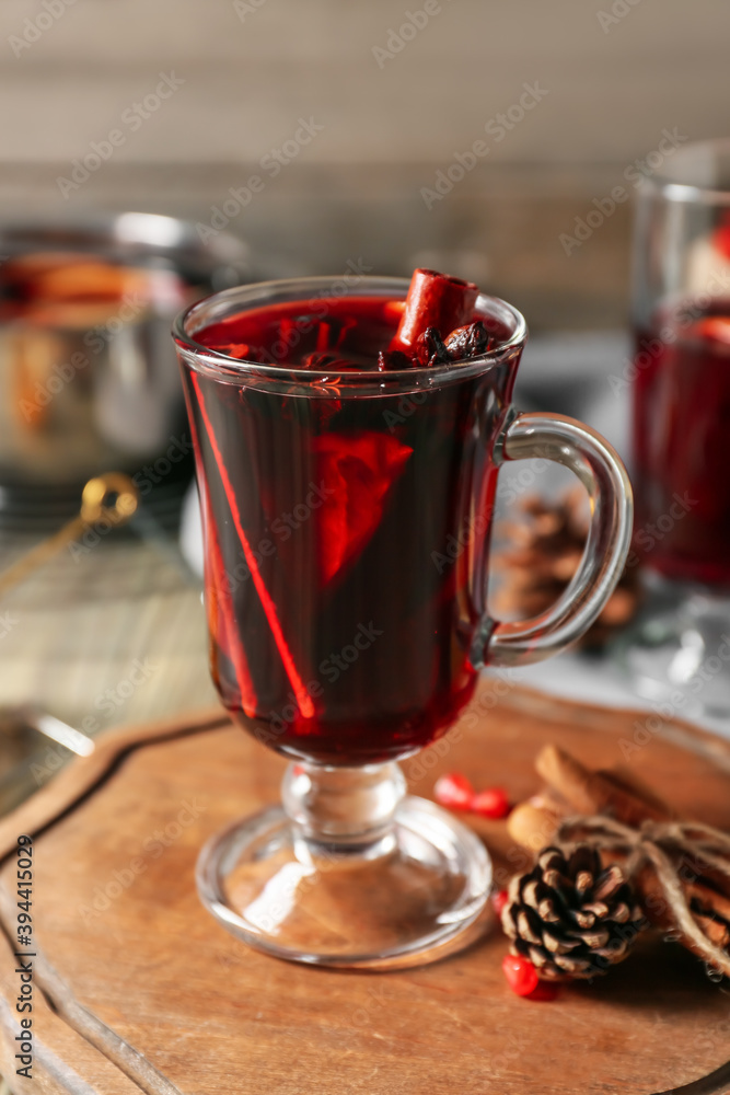 Glass cup of tasty mulled wine on table