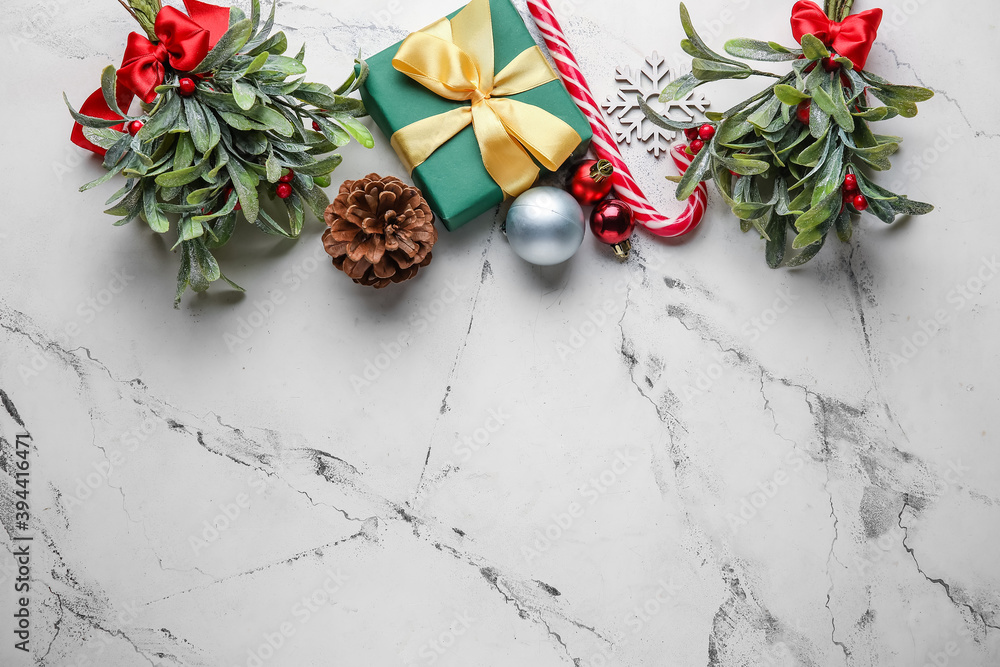 Christmas composition with mistletoe branches and decor on white background