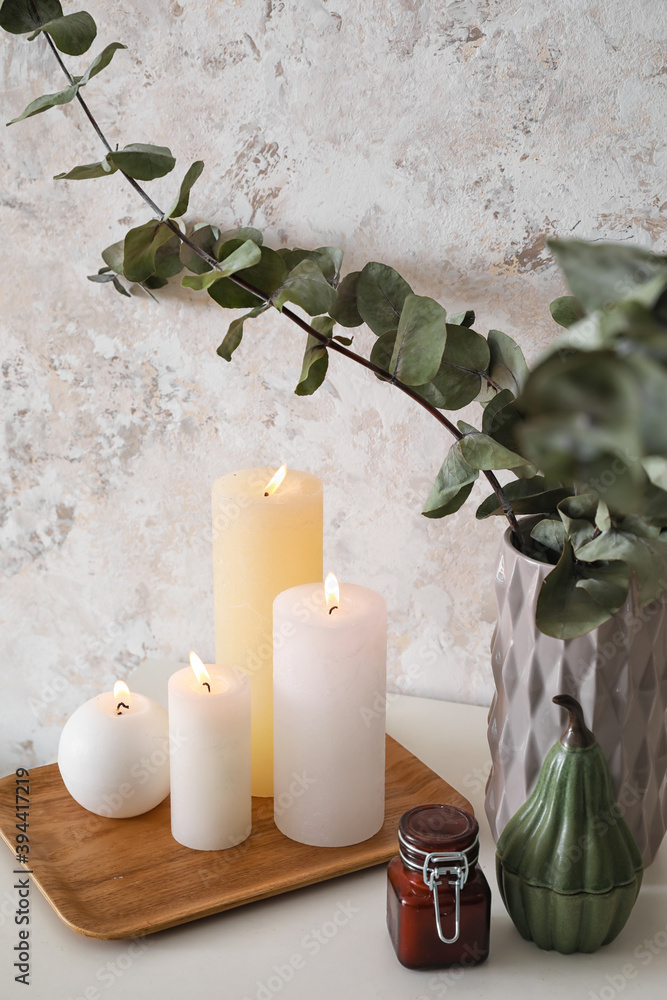 Table with burning candles in interior of room