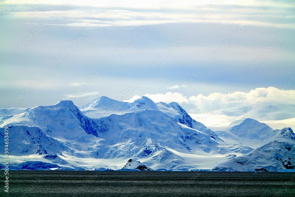 The white clouds are like an oily canvas. The iceberg and the sea are part of the canvas.
