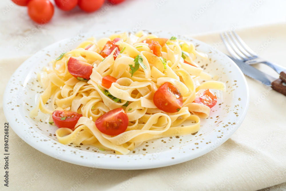 Plate with tasty pasta primavera on table