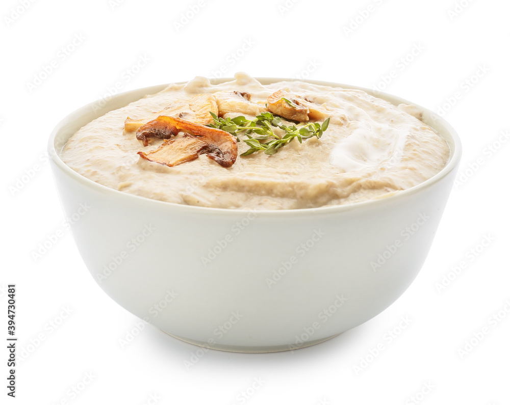 Bowl of tasty mushroom cream soup on white background