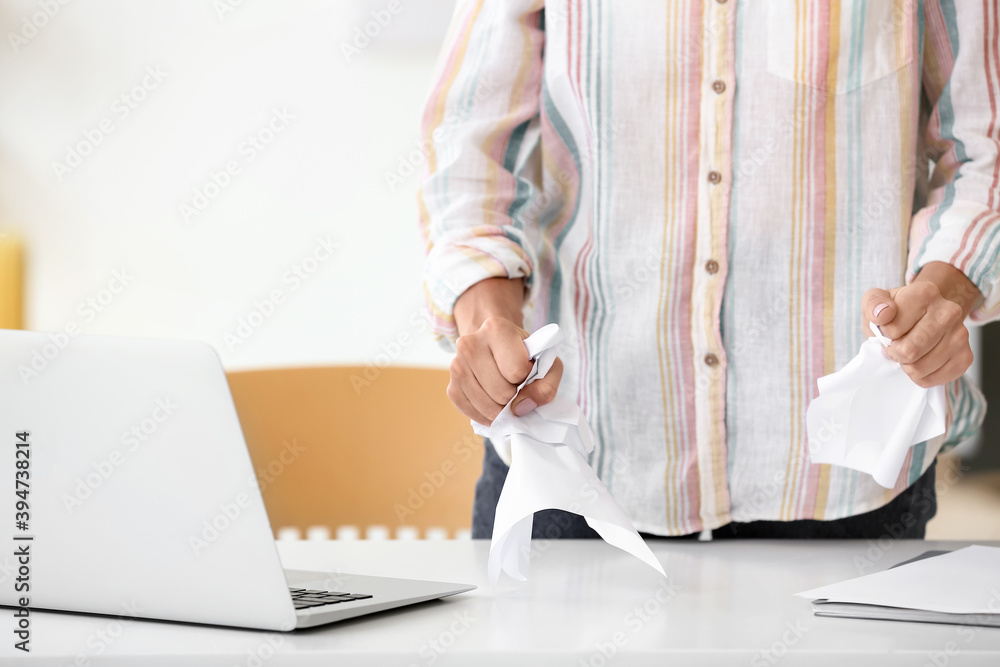 Stressed young businesswoman in office