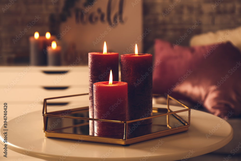 Beautiful aroma candles on table in dark room