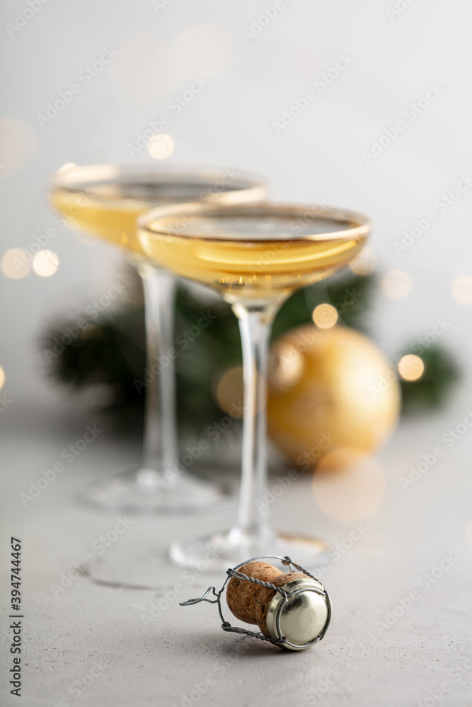 Two champagne glasses, cork and Christmas decorations