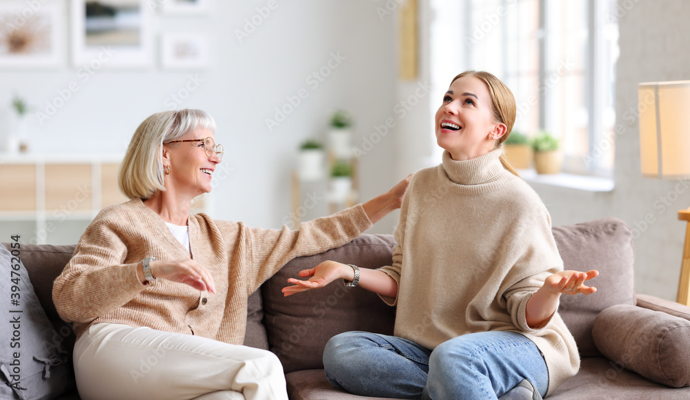 Mother listening to daughter telling funny story.