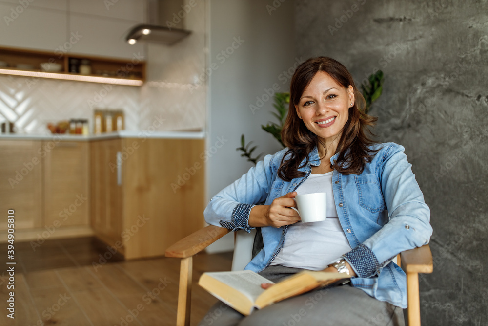 Drinking her favorite coffee, smiling.