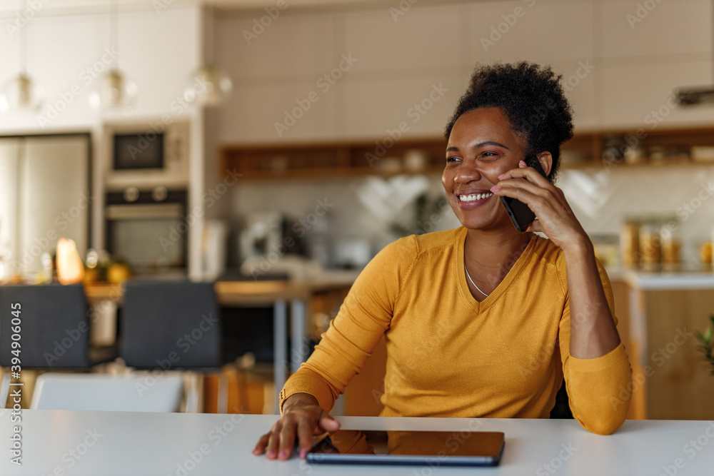 Digital tablet on the table, smiling woman.