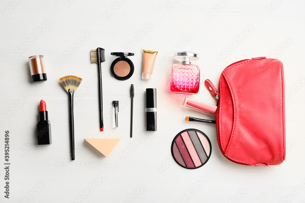 Set of decorative cosmetics with bag on light background