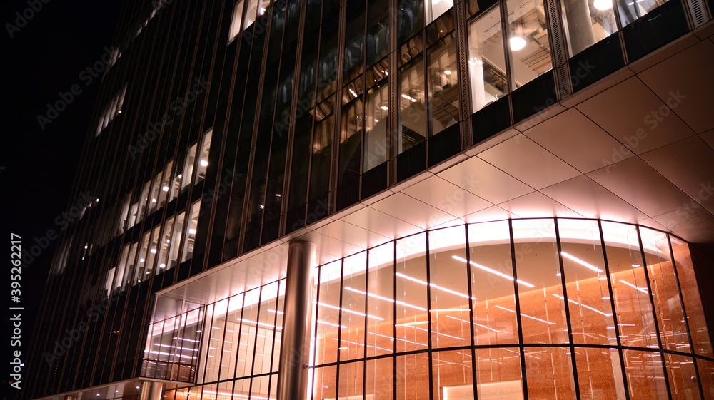 Pattern of office buildings windows illuminated at night. Lighting with Glass architecture facade de