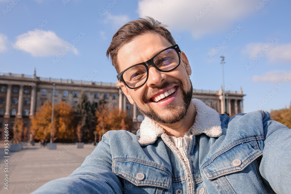 Handsome man taking selfie outdoors