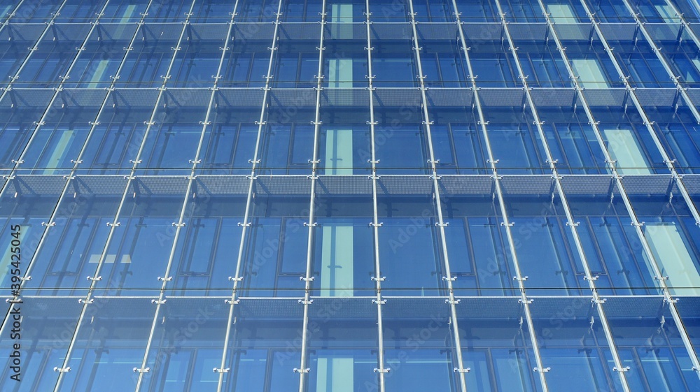 Facade texture of a glass mirrored office building. Fragment of the facade. Modern architecture of t