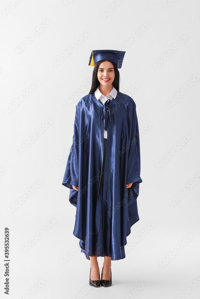 Female graduating student on light background