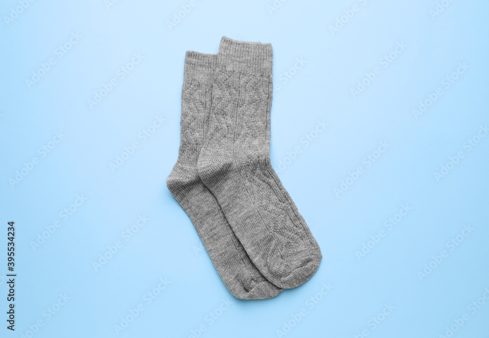 Warm socks on color background