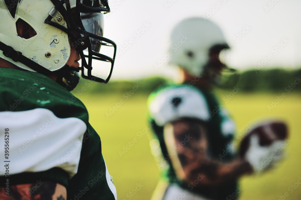 American football player standing with teammates before a game