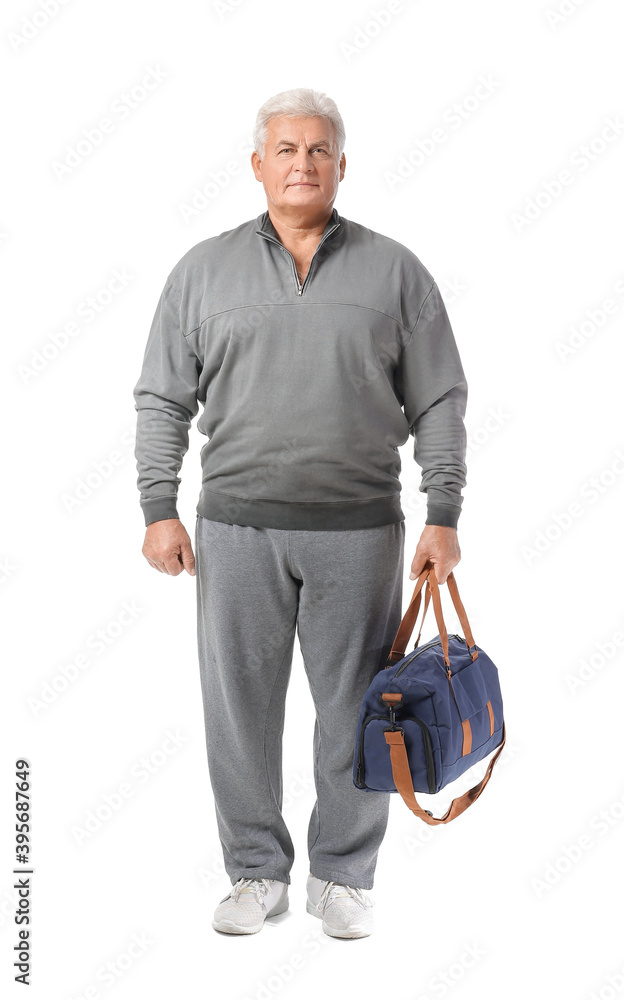 Sporty senior man with bag on white background