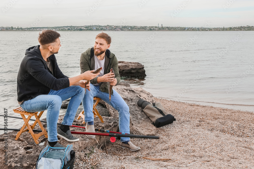 Young men fishing on river