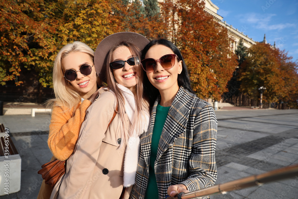 Beautiful young women taking selfie outdoors