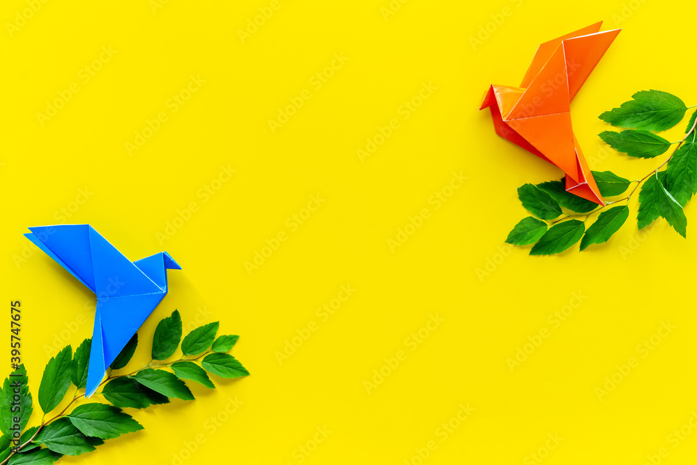 Colored origami - paper birds with leaves, overhead view