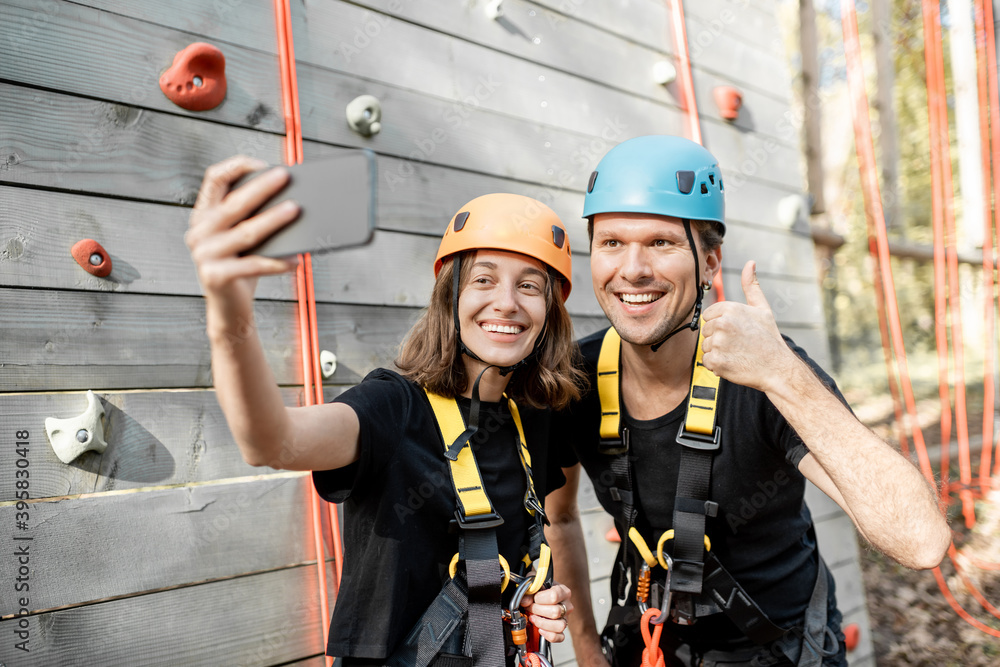 Friends in protective sports equipment taking a selfie photo together, climbers feeling happy in the