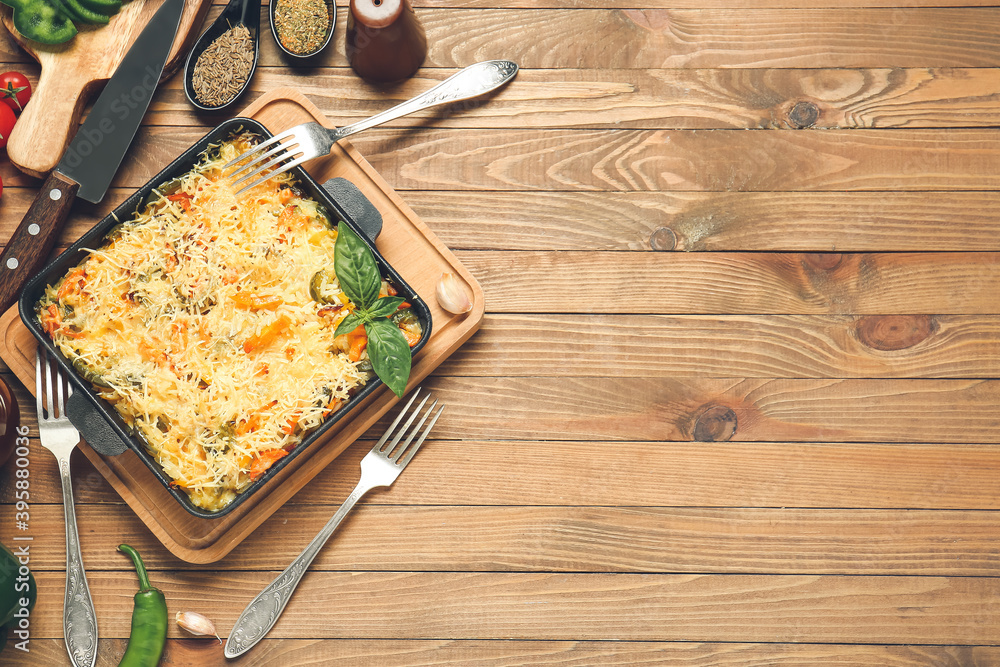 Baking dish with tasty rice casserole on table