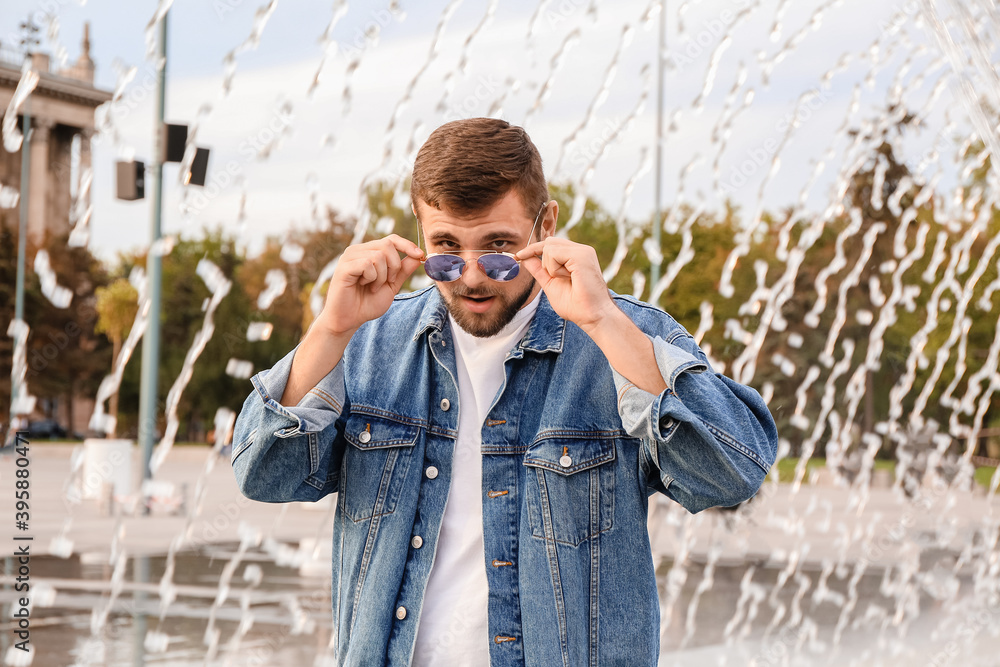 Handsome man with stylish sunglasses outdoors